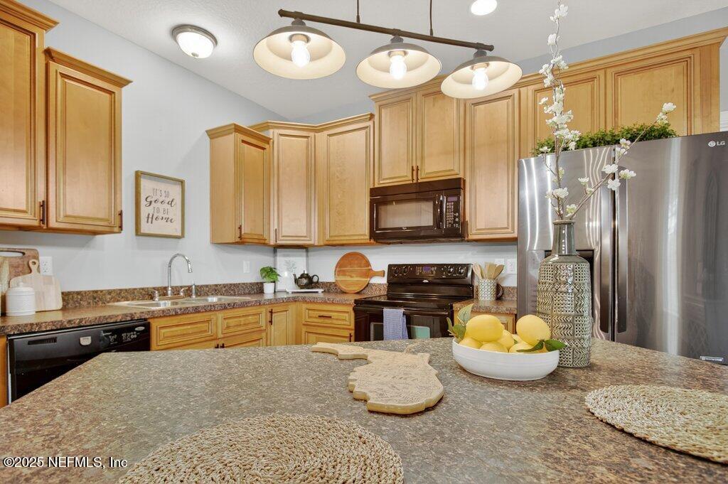 204 Comer Road Palatka, FL 32177 - Photo 21 of 61 a kitchen with stainless steel appliances granite countertop a sink a stove cabinets and a refrigerator