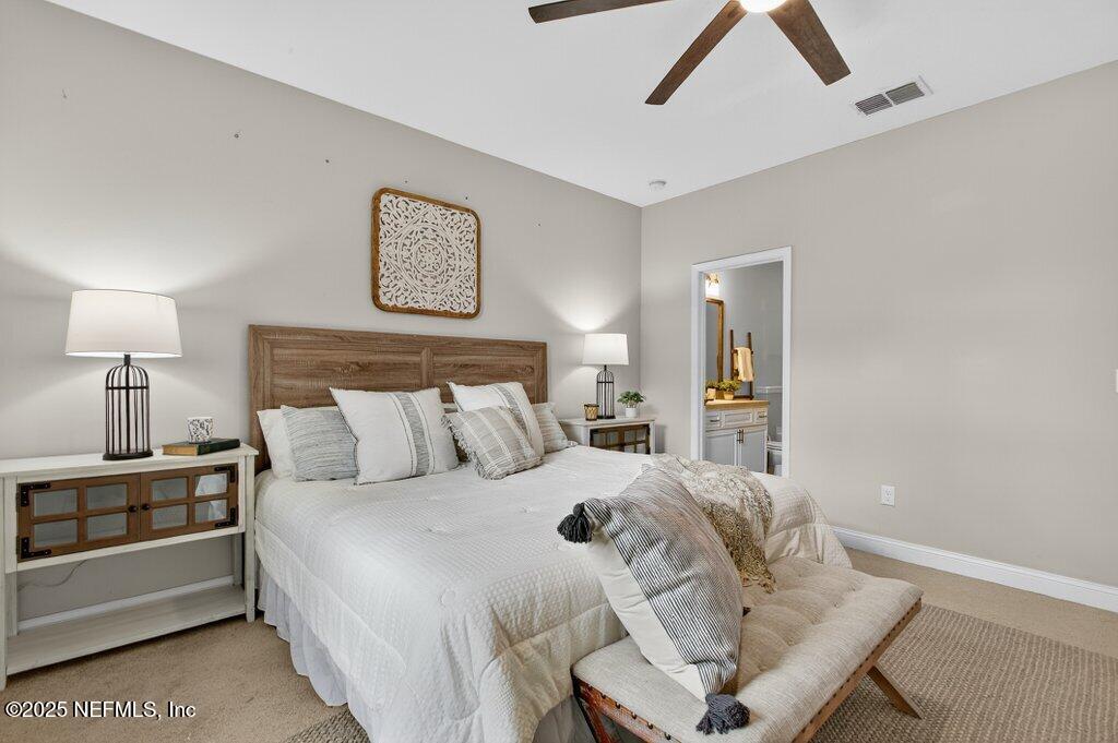 204 Comer Road Palatka, FL 32177 - Photo 23 of 61 a bedroom with a bed and a lamp on table