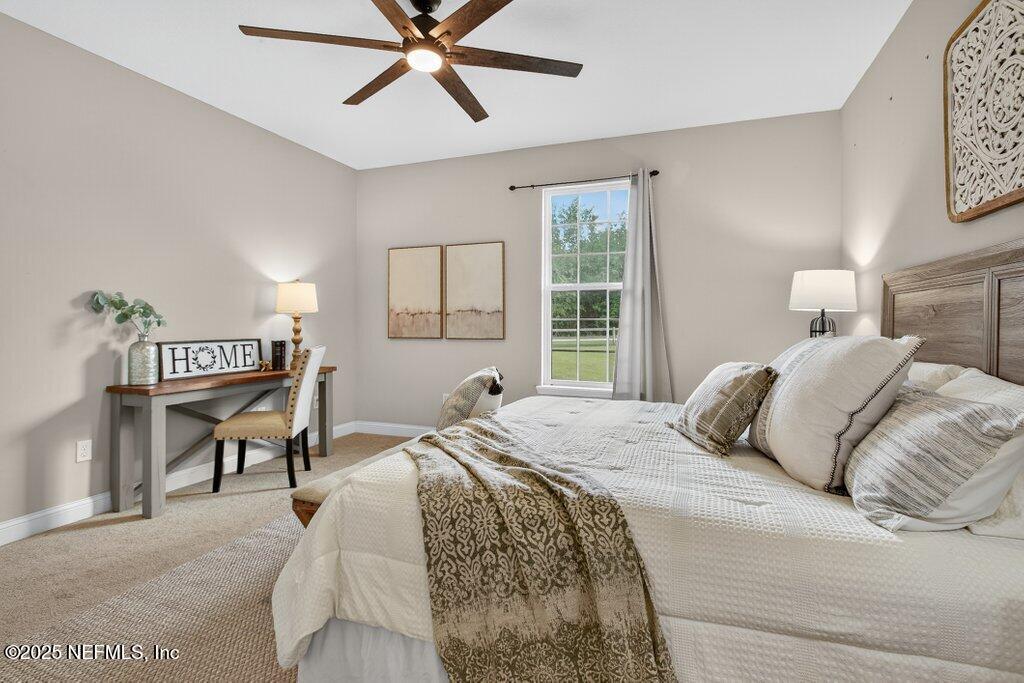 204 Comer Road Palatka, FL 32177 - Photo 25 of 61 a bedroom with a bed and a chandelier