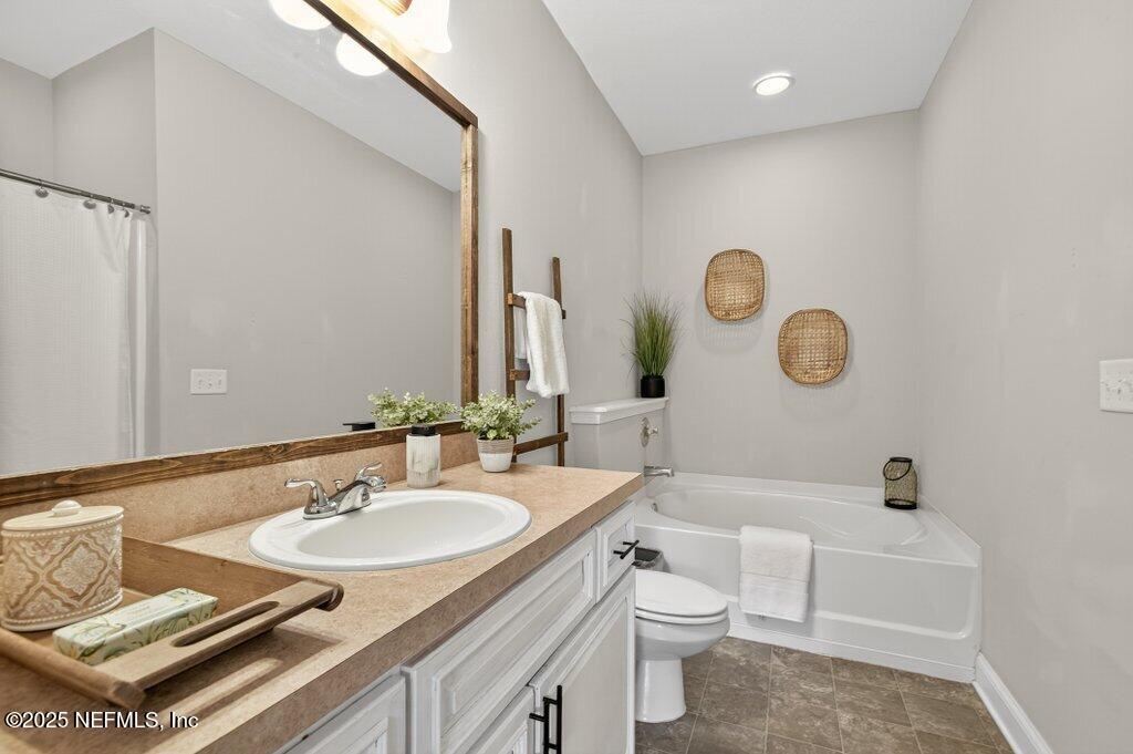 204 Comer Road Palatka, FL 32177 - Photo 28 of 61 a bathroom with a sink toilet a mirror and tub