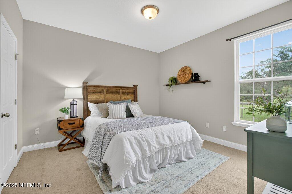 204 Comer Road Palatka, FL 32177 - Photo 30 of 61 a bedroom with a bed and window