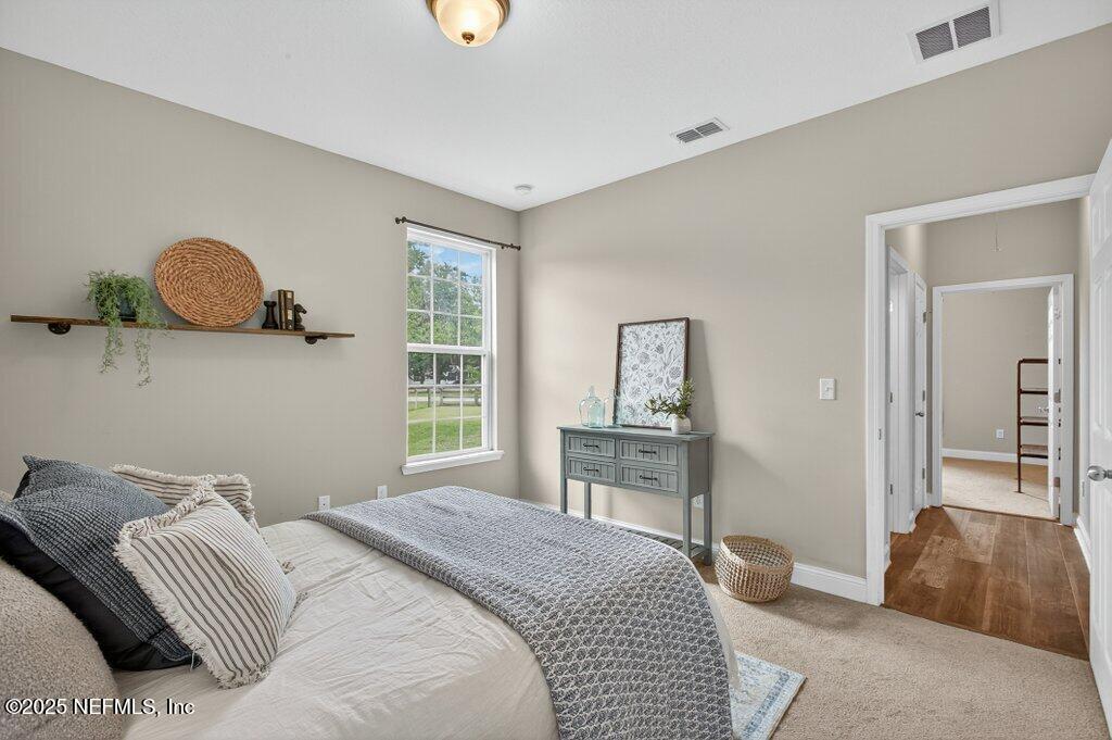 204 Comer Road Palatka, FL 32177 - Photo 32 of 61 a bedroom with a bed and wooden floor