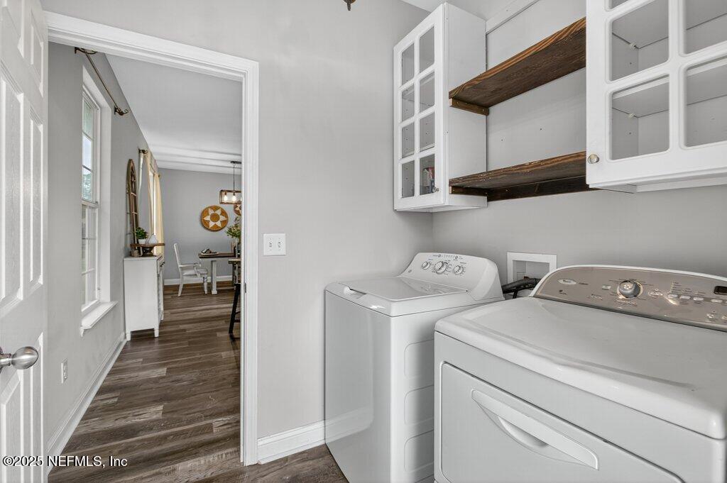 204 Comer Road Palatka, FL 32177 - Photo 37 of 61 a view of washer and dryer with wooden cabinets