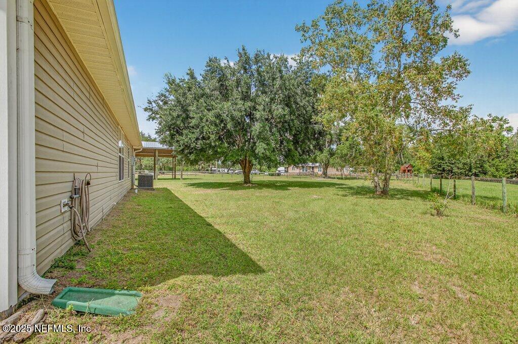204 Comer Road Palatka, FL 32177 - Photo 39 of 61 a view of yard with tree and a wooden fence