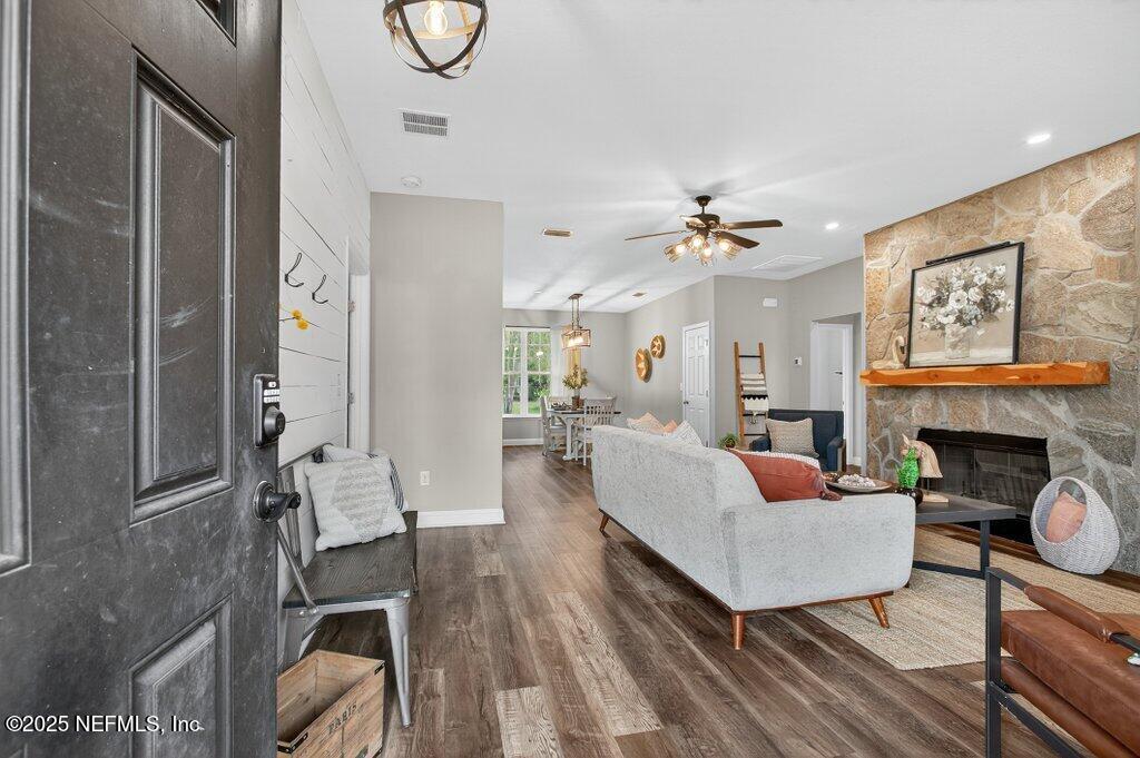 204 Comer Road Palatka, FL 32177 - Photo 6 of 61 a living room with fireplace furniture and a chandelier