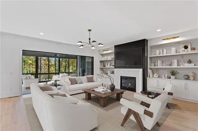 a living room with furniture a fireplace and a flat screen tv