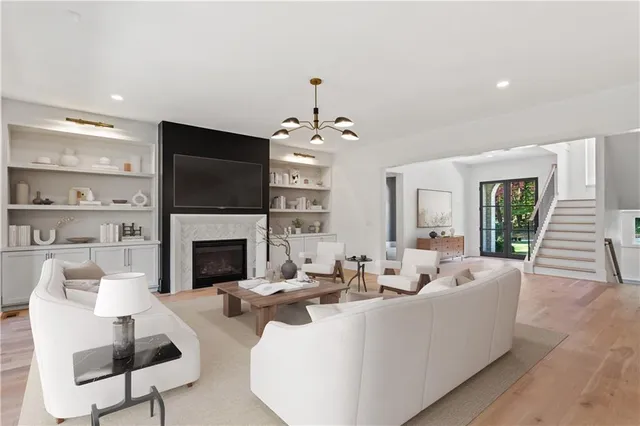 a living room with furniture a fireplace and a flat screen tv