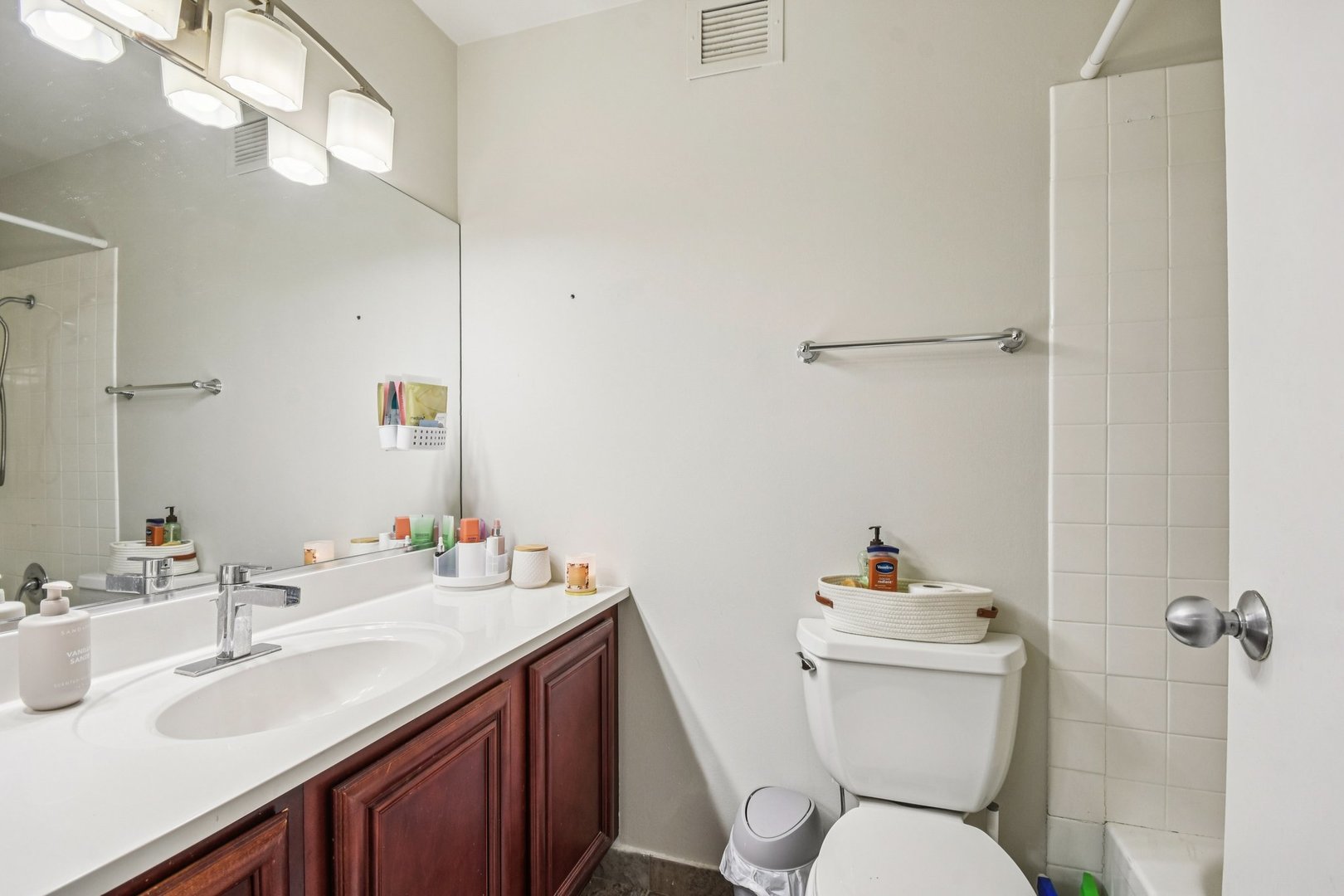 200 North Dearborn Street, Unit 1303 Chicago, IL 60601 - Photo 16 of 32 a bathroom with a toilet sink and mirror