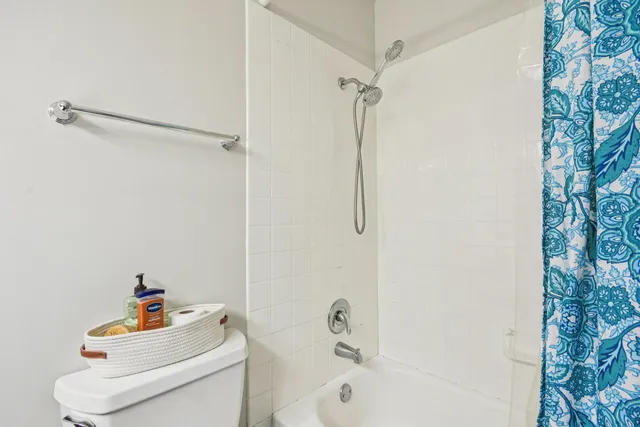 a white bath tub sitting next to a white toilet and sink