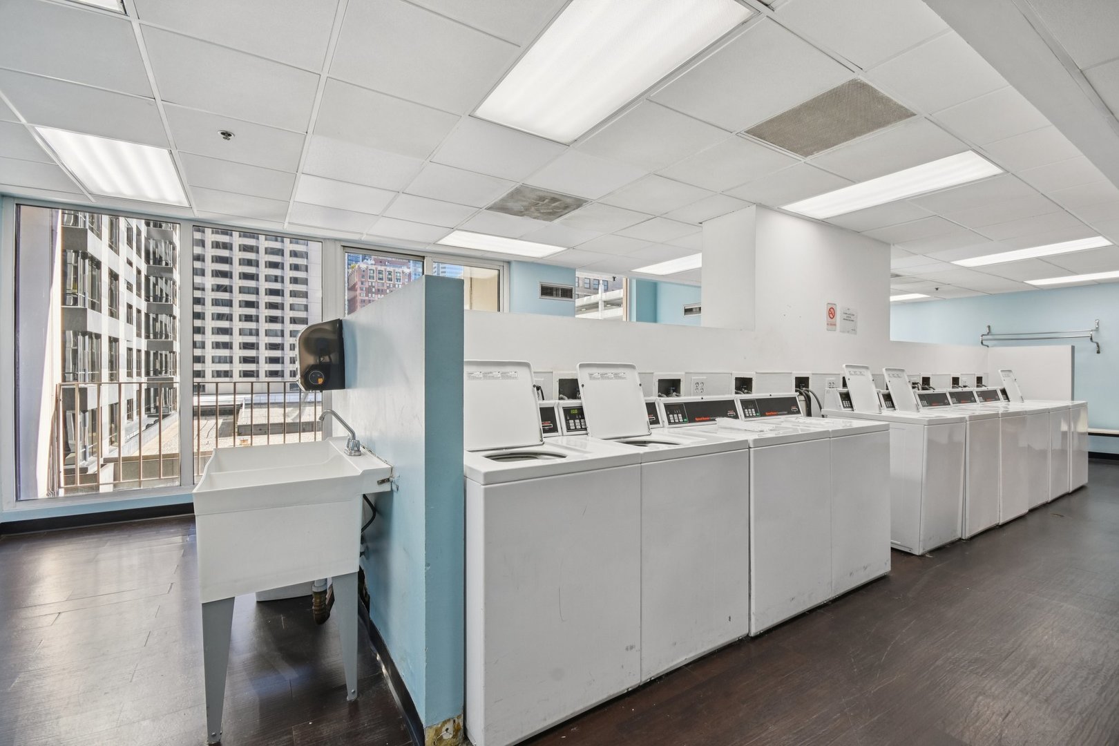 200 North Dearborn Street, Unit 1303 Chicago, IL 60601 - Photo 21 of 32 a kitchen with cabinets and wooden floor