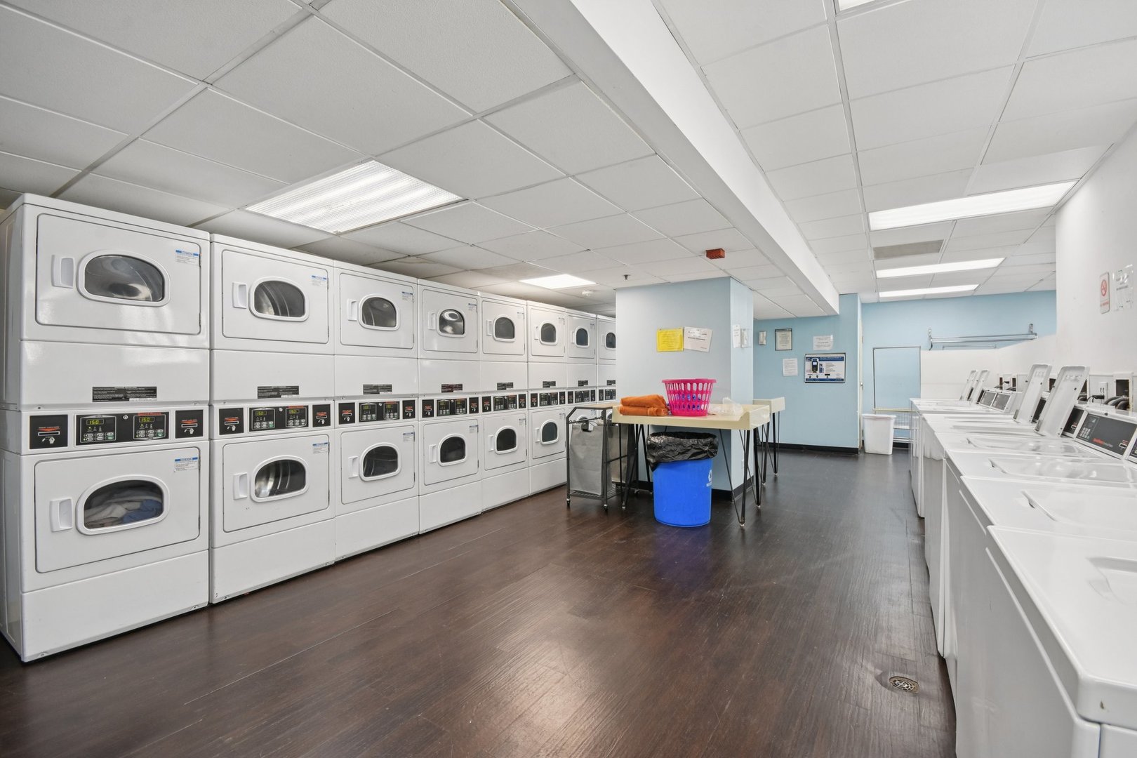 200 North Dearborn Street, Unit 1303 Chicago, IL 60601 - Photo 22 of 32 a large white kitchen with stainless steel appliances granite countertop a stove and a wooden floors