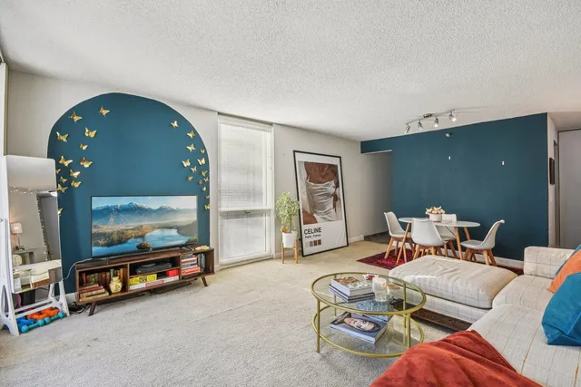 a living room with furniture and a mirror