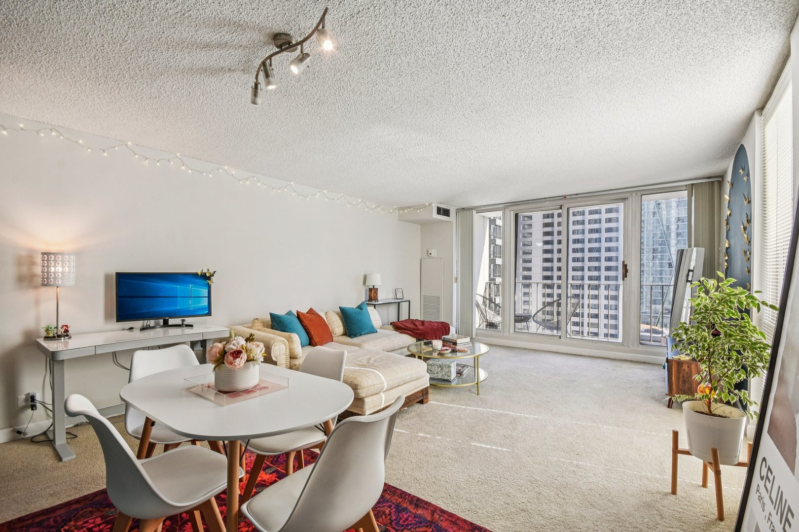 200 North Dearborn Street, Unit 1303 Chicago, IL 60601 - Photo 6 of 32 a living room with furniture and a potted plant