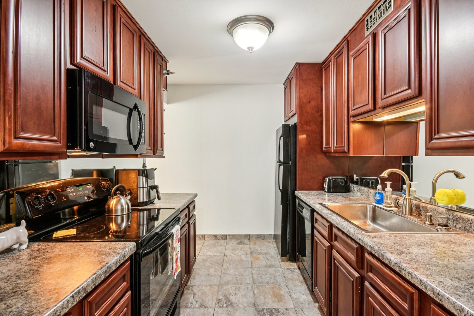 200 North Dearborn Street, Unit 1303 Chicago, IL 60601 - Photo 9 of 32 a kitchen with stainless steel appliances granite countertop a sink stove and cabinets
