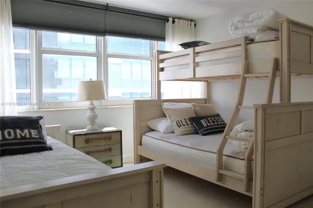 a bedroom with a bed and lamp