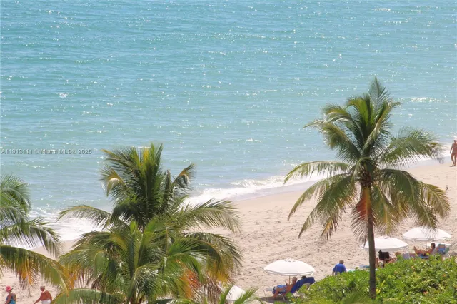 a view of a lake with a floor to ceiling window and potted plants