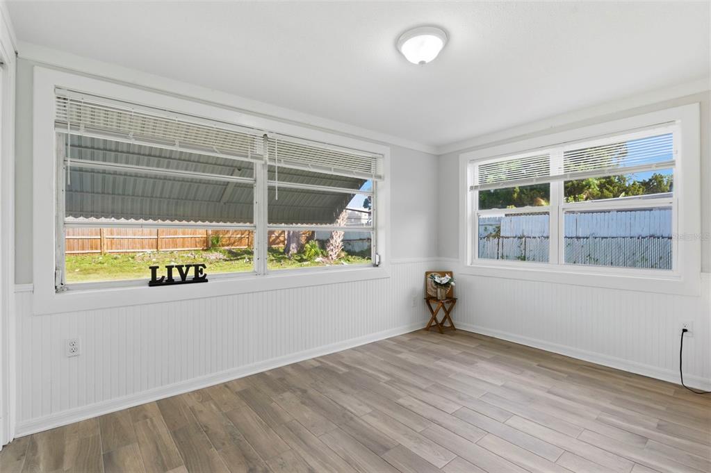 9033 Pegasus Avenue Port Richey, FL 34668 - Photo 20 of 56 a view of an empty room with a window and wooden floor