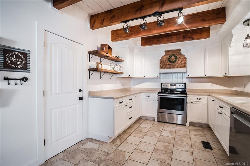 2350 Phifer Road Cleveland, NC 27013 - Photo 15 of 36 a kitchen with stainless steel appliances a stove and cabinets