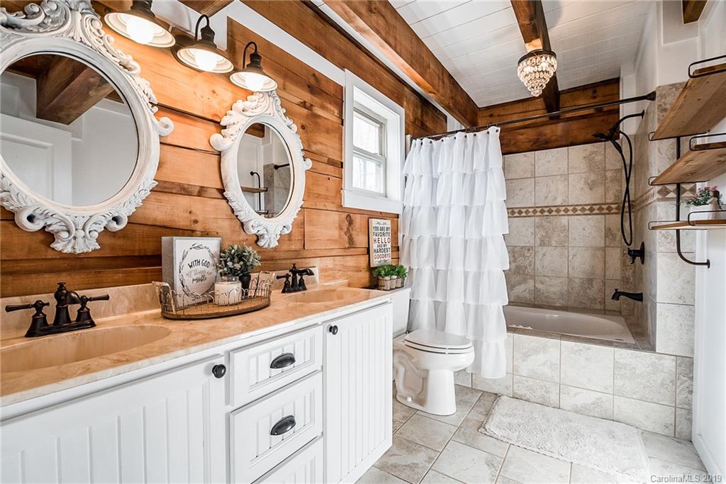 2350 Phifer Road Cleveland, NC 27013 - Photo 19 of 36 a bathroom with a double vanity sink toilet and shower