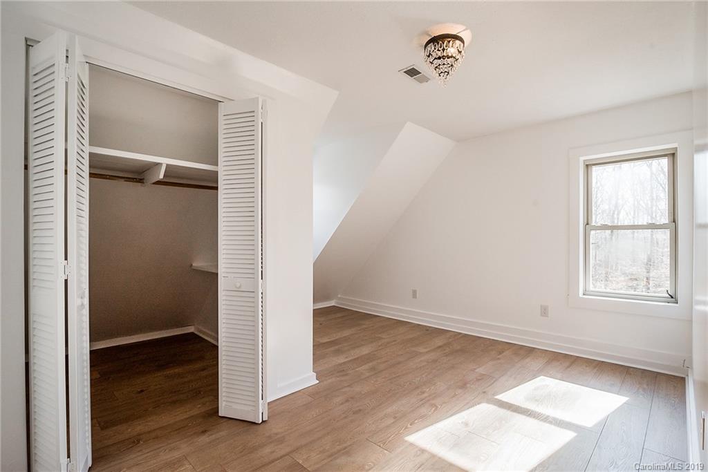 2350 Phifer Road Cleveland, NC 27013 - Photo 22 of 36 an empty room with wooden floor and windows