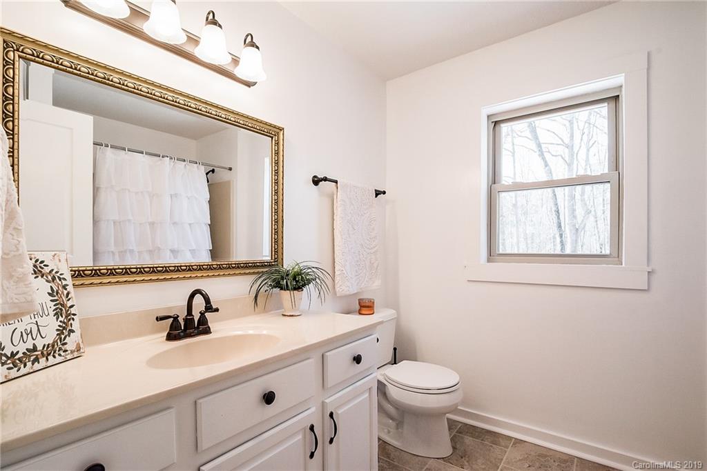 2350 Phifer Road Cleveland, NC 27013 - Photo 23 of 36 a bathroom with a sink a toilet and a mirror