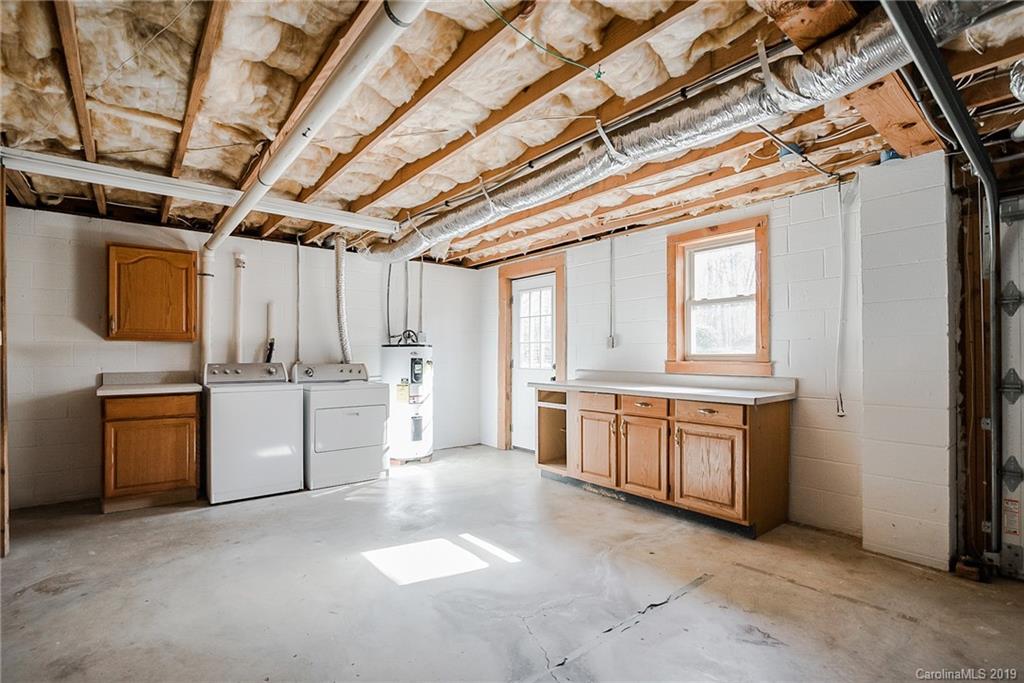 2350 Phifer Road Cleveland, NC 27013 - Photo 29 of 36 a large white kitchen with stove top oven and sink