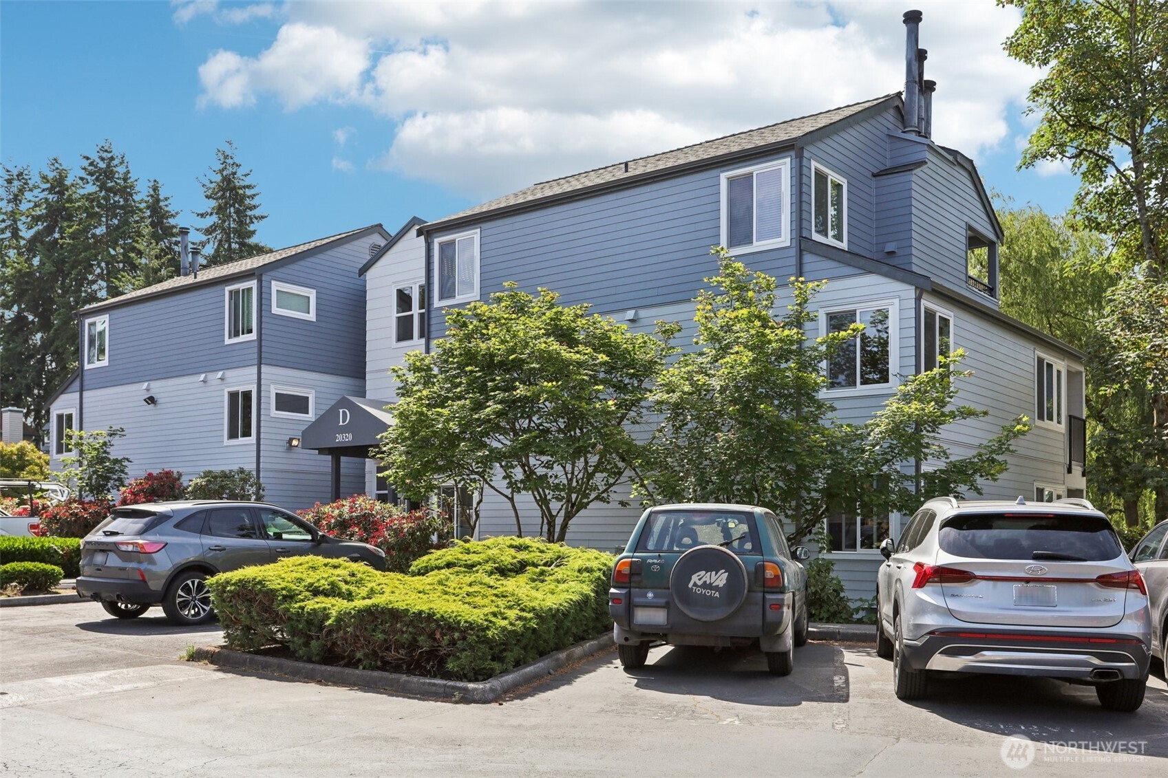 20320 Bothell Everett Highway, Unit D201 Bothell, WA 98012 - Photo 1 of 1 a car parked in front of a house