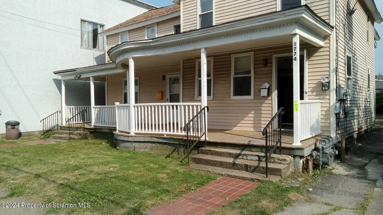 1774 Brick Avenue, Unit 1 Scranton, PA 18508 - Photo 1 of 8 front view of a house with a yard