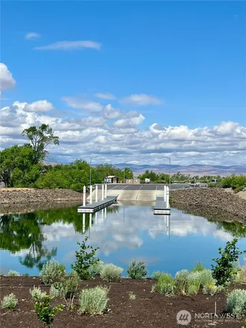 a view of a lake with houses in the back