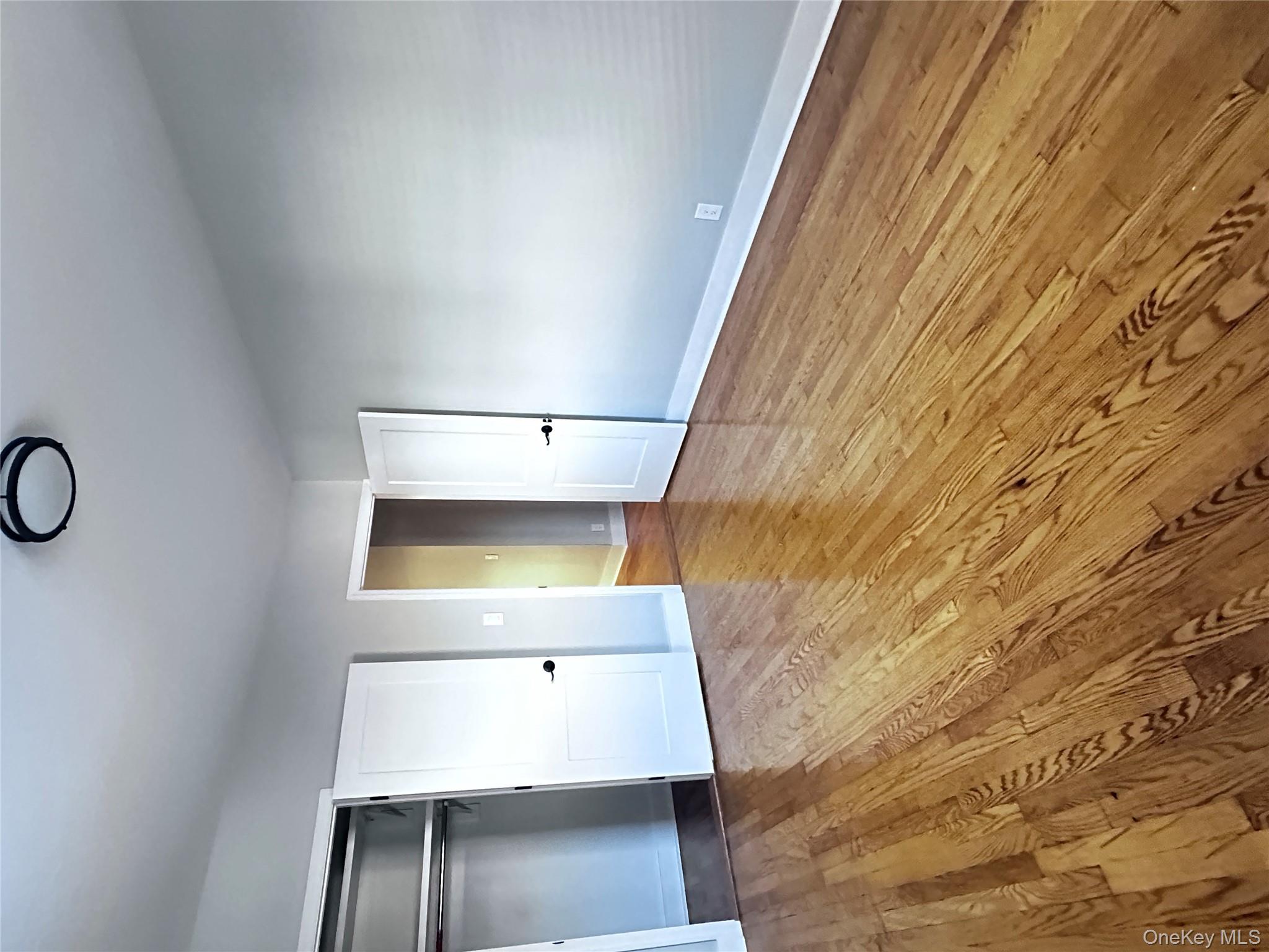 1233 Lydig Avenue, Unit 1 Bronx, NY 10461 - Photo 14 of 20 a view of an empty room with wooden floor and windows