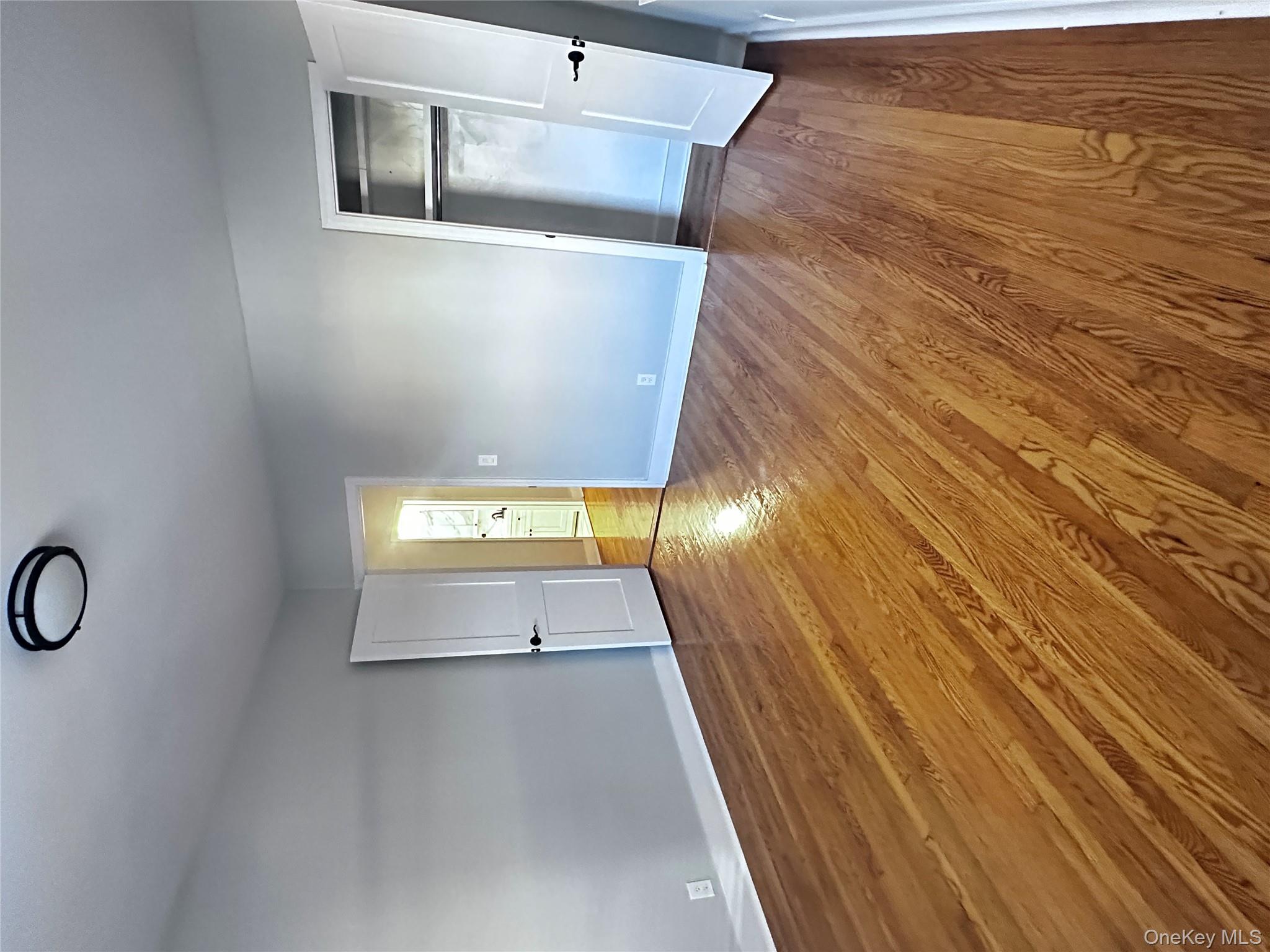 1233 Lydig Avenue, Unit 1 Bronx, NY 10461 - Photo 17 of 20 a view of empty room with wooden floor