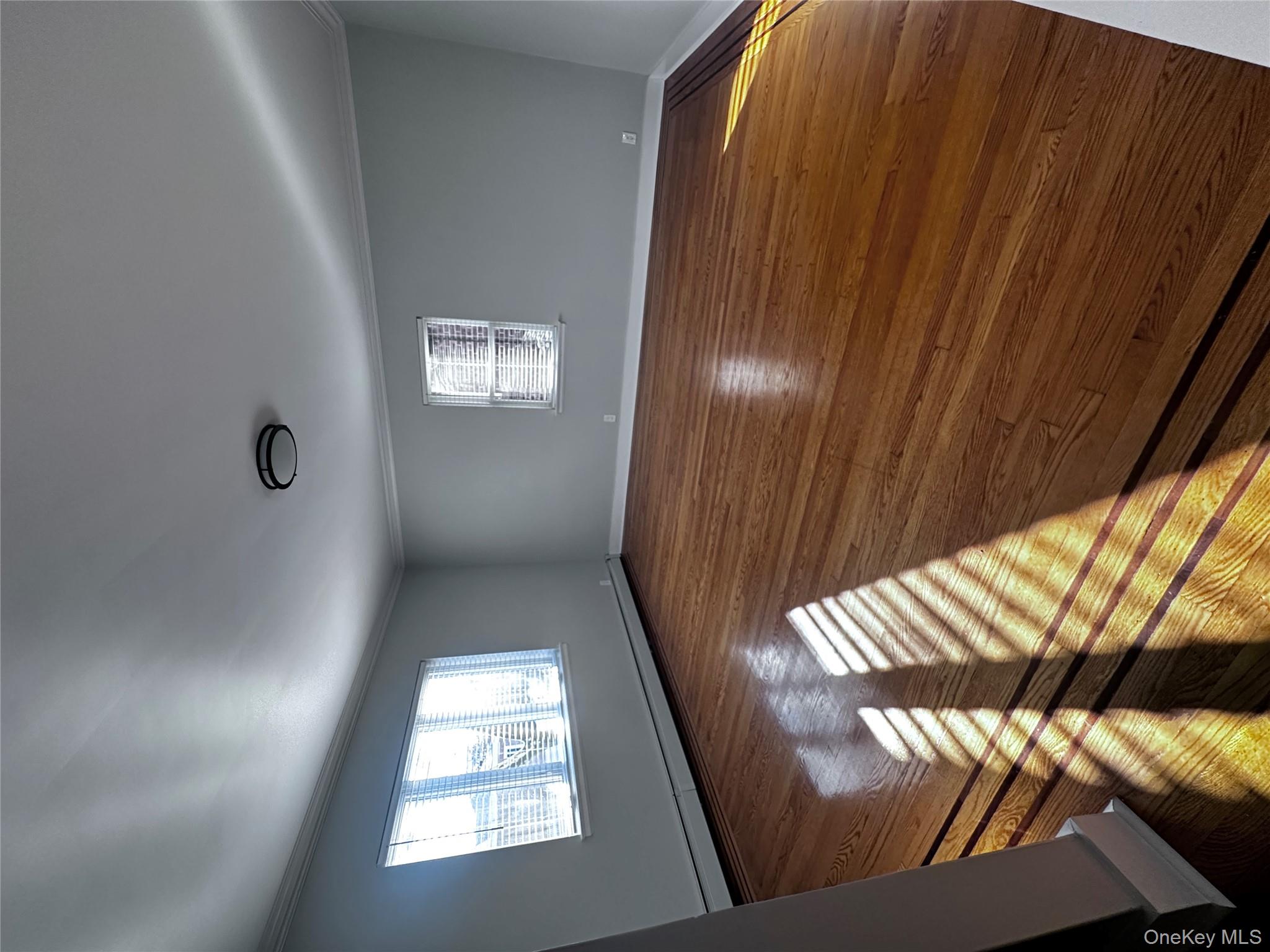 1233 Lydig Avenue, Unit 1 Bronx, NY 10461 - Photo 2 of 20 an empty room with wooden floor and windows