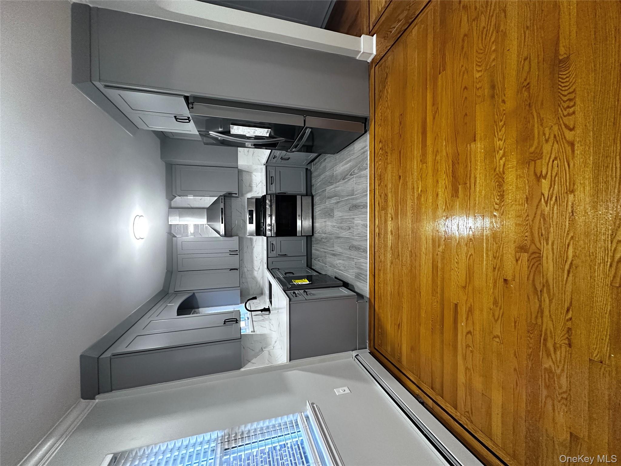 1233 Lydig Avenue, Unit 1 Bronx, NY 10461 - Photo 3 of 20 a view of kitchen and empty room with wooden floor