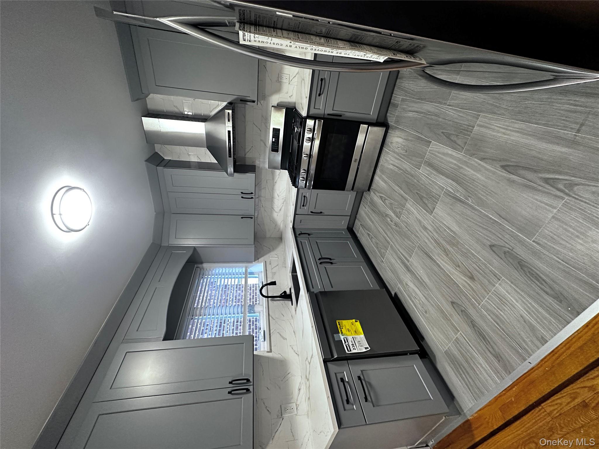 1233 Lydig Avenue, Unit 1 Bronx, NY 10461 - Photo 5 of 20 a kitchen with stainless steel appliances granite countertop a stove a sink and a refrigerator