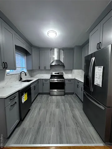 a kitchen with granite countertop stainless steel appliances and wooden cabinets
