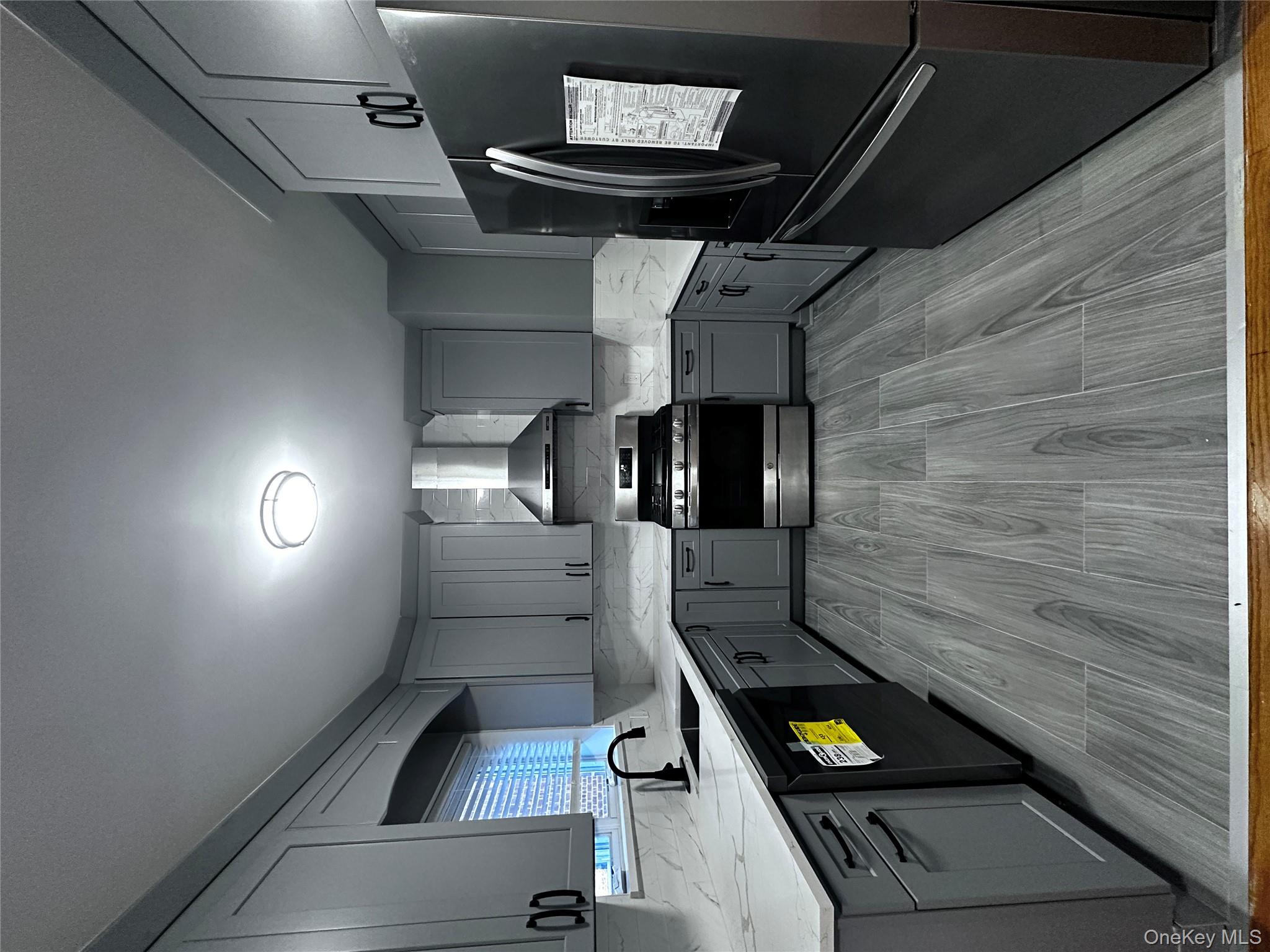 1233 Lydig Avenue, Unit 1 Bronx, NY 10461 - Photo 6 of 20 a kitchen with granite countertop stainless steel appliances and wooden cabinets