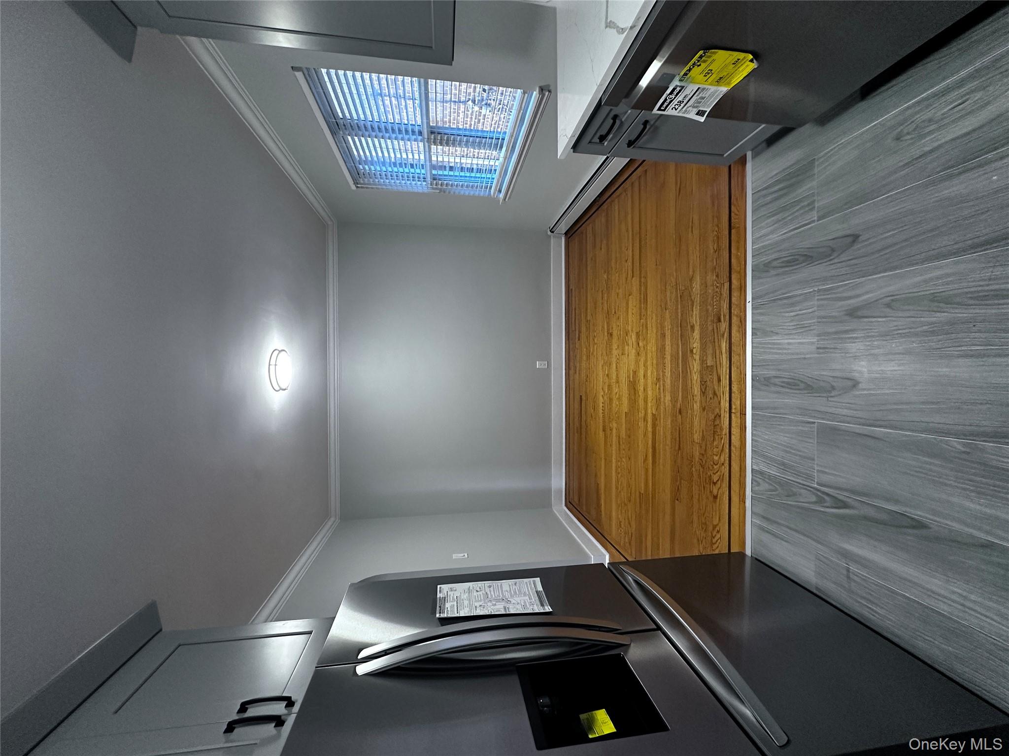 1233 Lydig Avenue, Unit 1 Bronx, NY 10461 - Photo 7 of 20 an empty room with wooden floor and windows