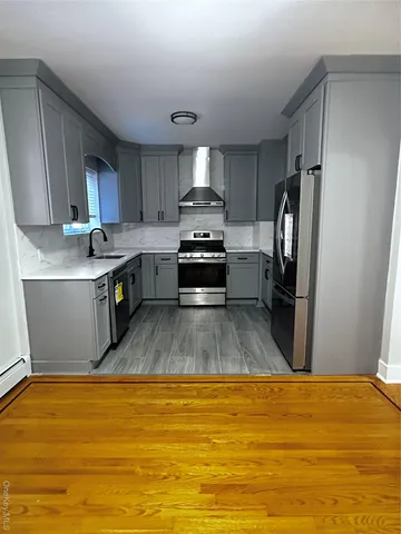 a kitchen with stainless steel appliances granite countertop a stove a refrigerator and a stove