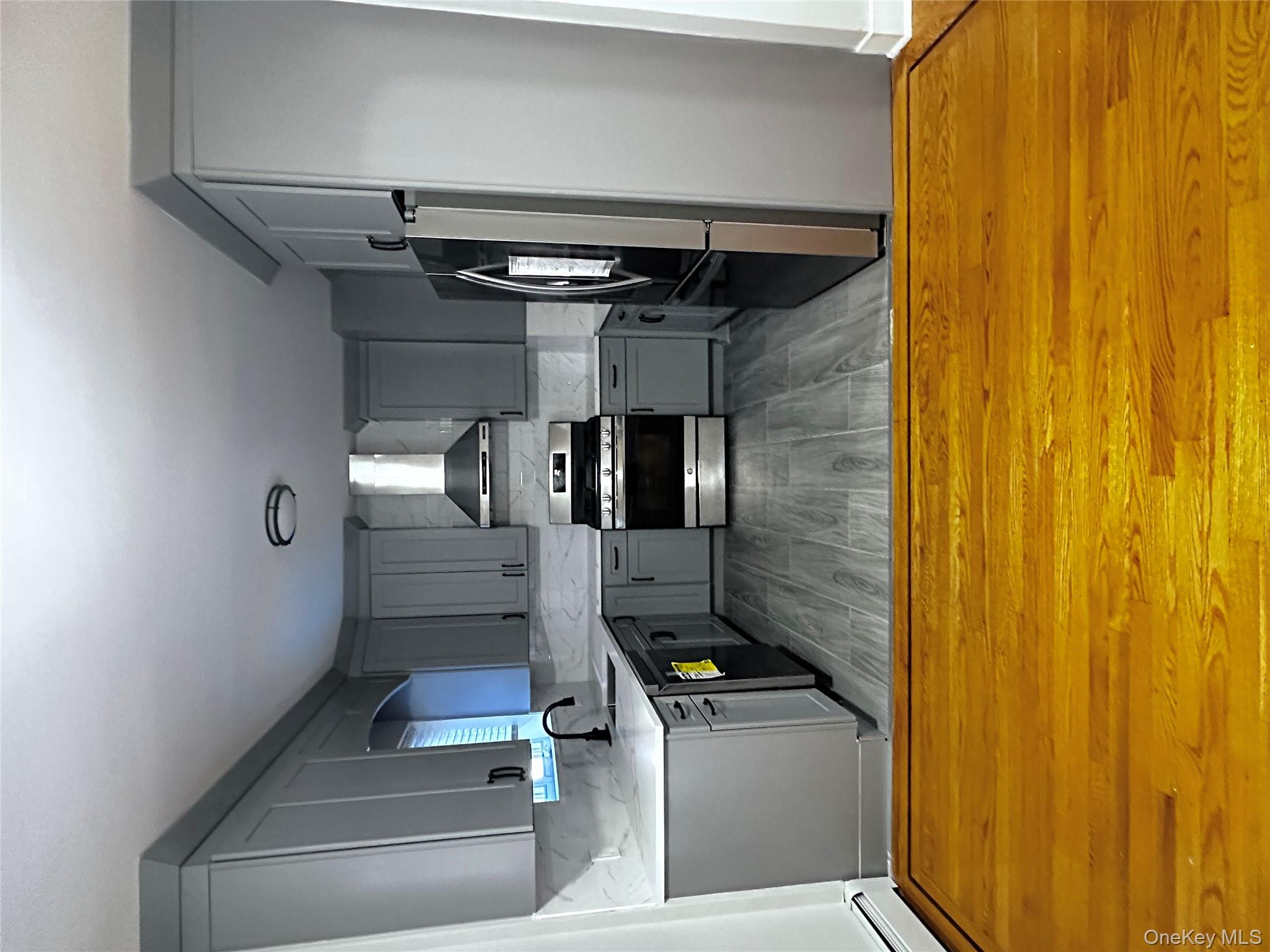 1233 Lydig Avenue, Unit 1 Bronx, NY 10461 - Photo 9 of 20 a kitchen with stainless steel appliances granite countertop a stove a refrigerator and a stove