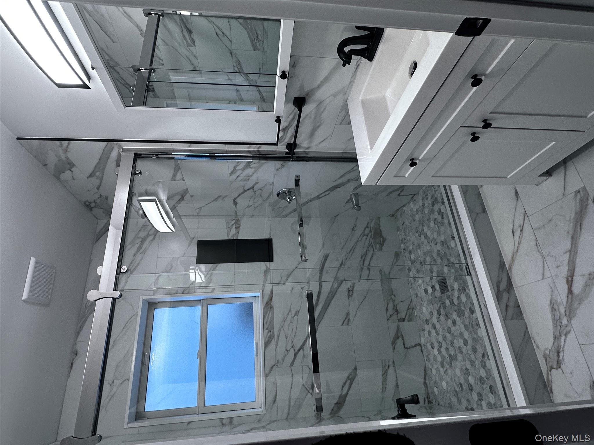 1233 Lydig Avenue, Unit 1 Bronx, NY 10461 - Photo 10 of 20 a bathroom with a sink a toilet and shower