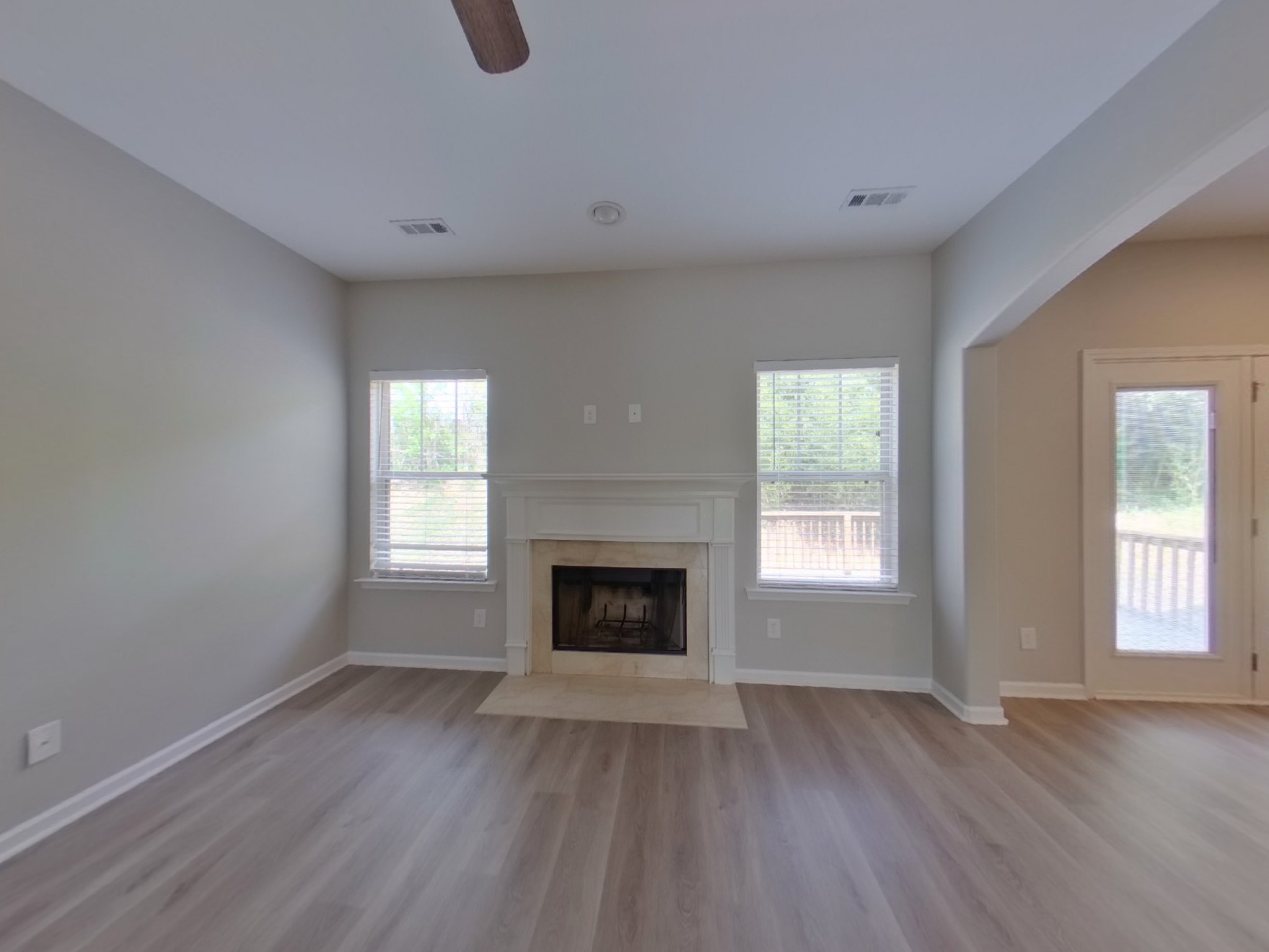7114 Colquitt Way Fairview, TN 37062 - Photo 2 of 16 a view of an empty room with wooden floor window and fire place