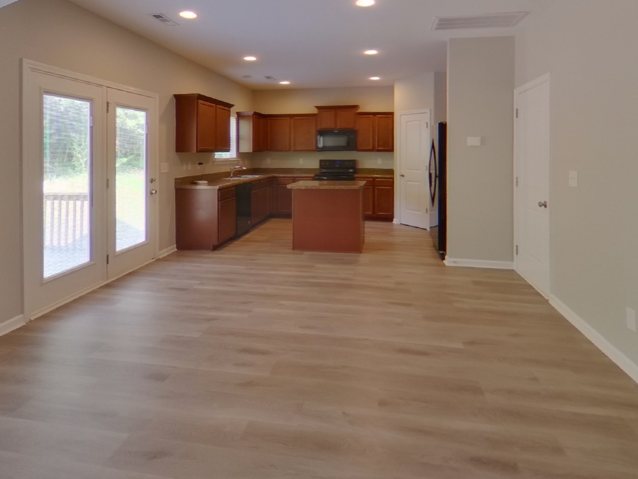 7114 Colquitt Way Fairview, TN 37062 - Photo 5 of 16 a open kitchen with kitchen island a sink dishwasher stove and refrigerator