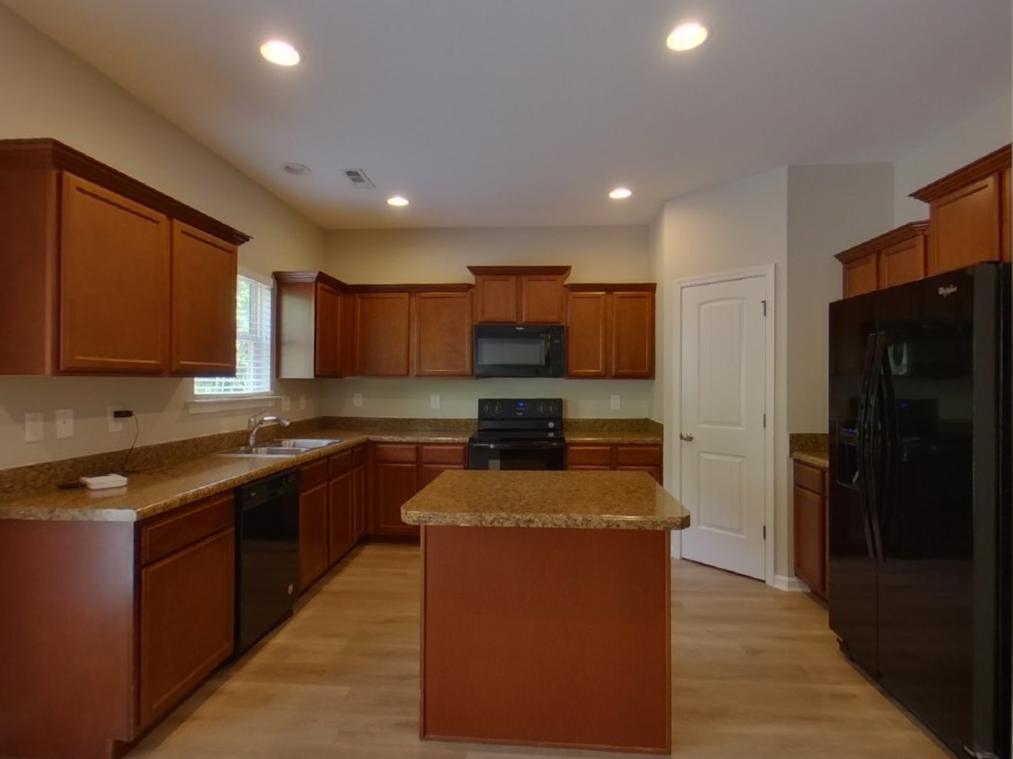 7114 Colquitt Way Fairview, TN 37062 - Photo 7 of 16 a kitchen with stainless steel appliances granite countertop wooden cabinets a stove a sink and a refrigerator