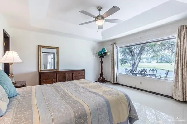 a bedroom with a large bed and a large window