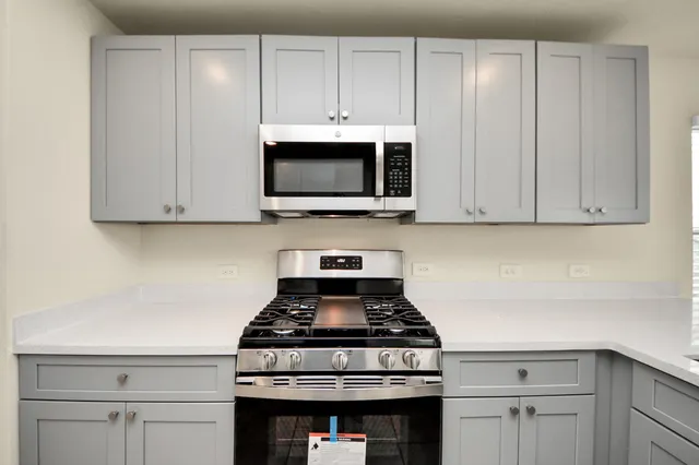 a stove top oven sitting inside of a kitchen