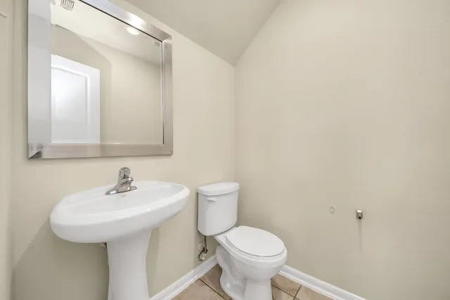 a bathroom with a sink a toilet and mirror