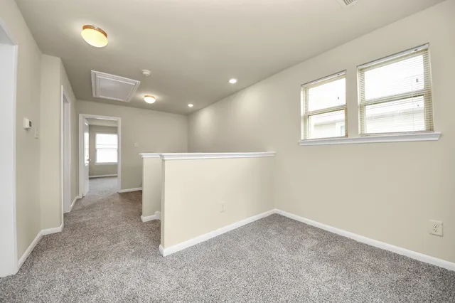 an entryway in a hall with a window