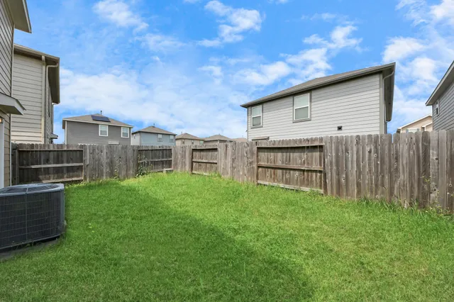 a view of house with backyard