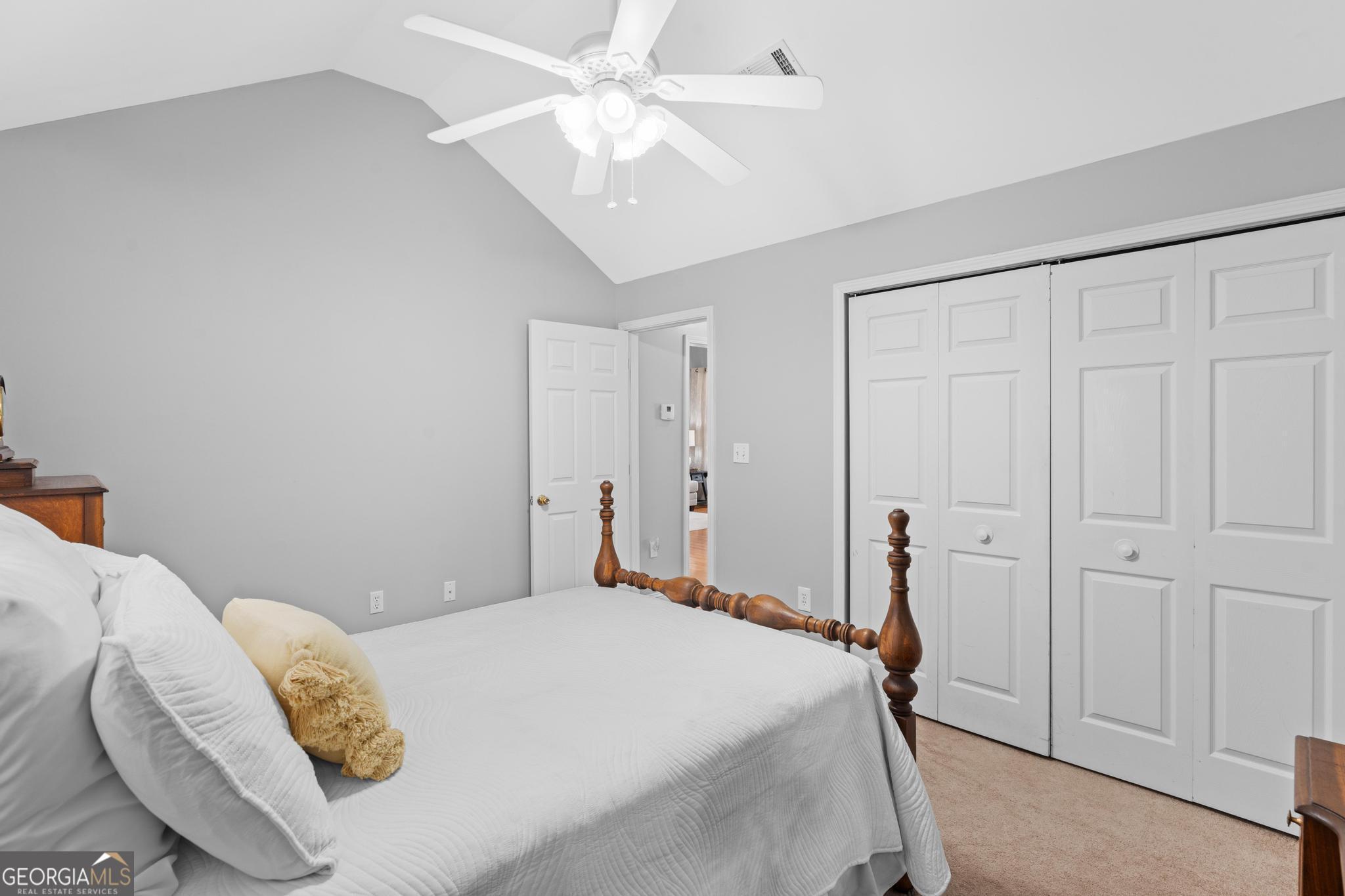 291 Lora Smith Road Newnan, GA 30265 - Photo 12 of 37 a bedroom with a bed and a ceiling fan