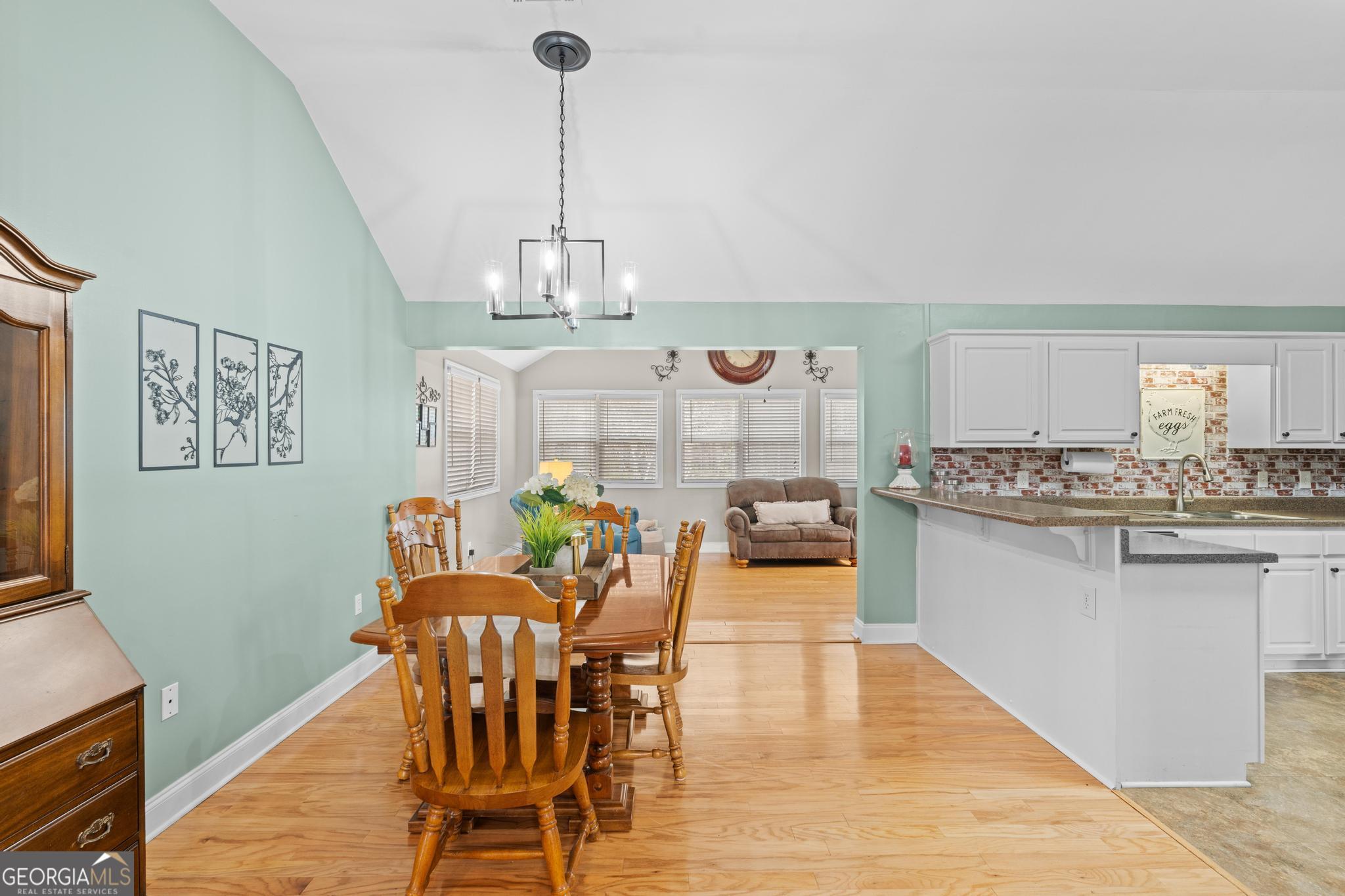 291 Lora Smith Road Newnan, GA 30265 - Photo 13 of 37 a view of a dining room with furniture window and wooden floor